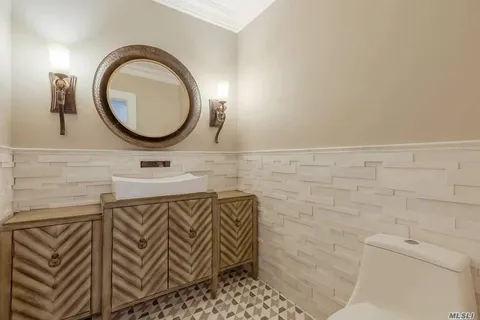 a bathroom with a sink a mirror and a shower
