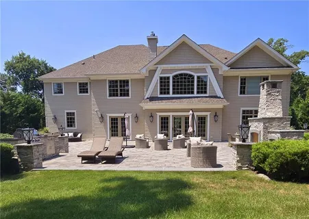 a front view of a house with a yard table and chairs