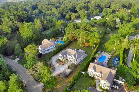 an aerial view of a house with a yard and lake view