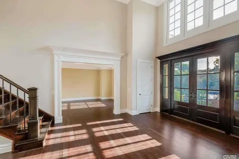a view of a room with wooden floor and windows