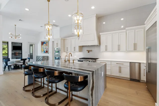 a living room with fireplace furniture and a large window