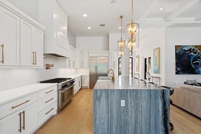 a kitchen with stainless steel appliances granite countertop a sink and cabinets