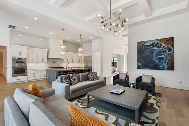 a living room with furniture and a chandelier