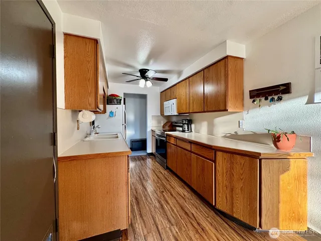 a kitchen with stainless steel appliances granite countertop a sink and a refrigerator