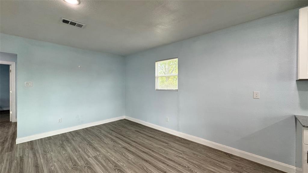 191 Harmon Road Gun Barrel City, TX 75156 - Photo 11 of 28 a view of empty room with wooden floor and fan