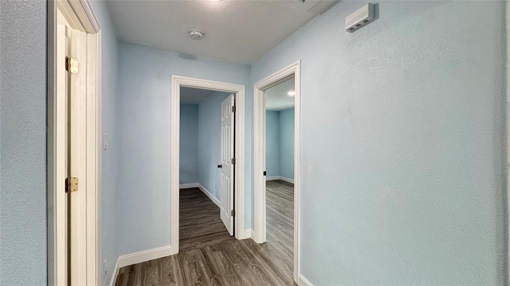 191 Harmon Road Gun Barrel City, TX 75156 - Photo 12 of 28 a view of a hallway with wooden floor and staircase