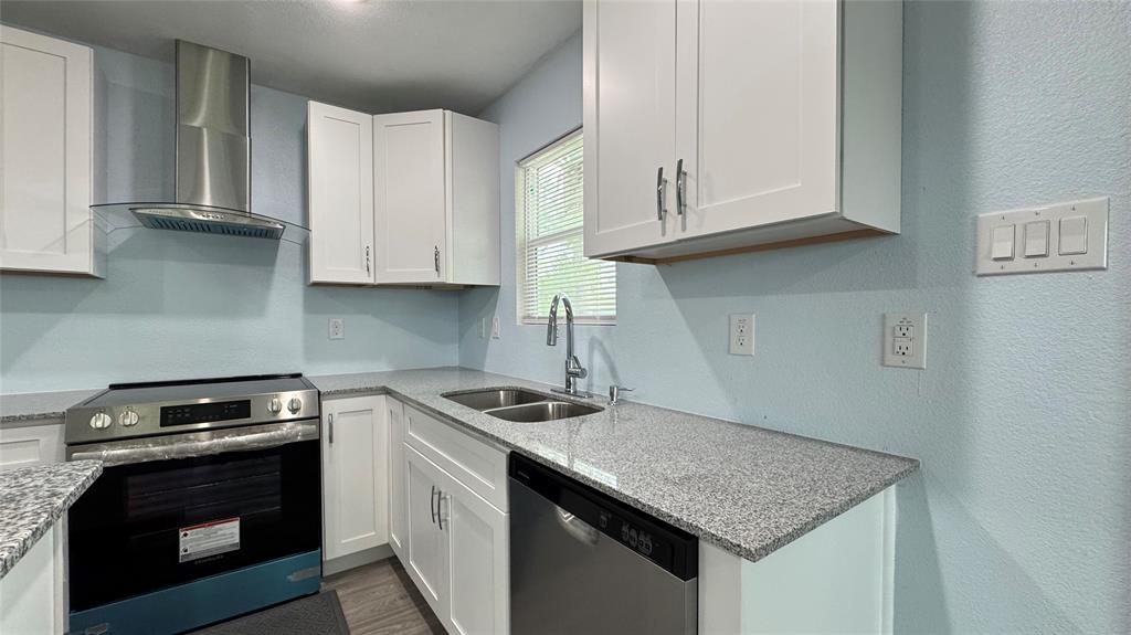 191 Harmon Road Gun Barrel City, TX 75156 - Photo 12 of 31 a kitchen with stainless steel appliances granite countertop a sink stove and cabinets