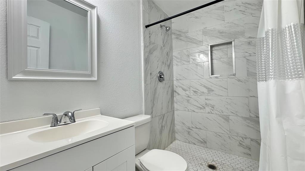 191 Harmon Road Gun Barrel City, TX 75156 - Photo 15 of 31 a bathroom with a sink toilet and shower