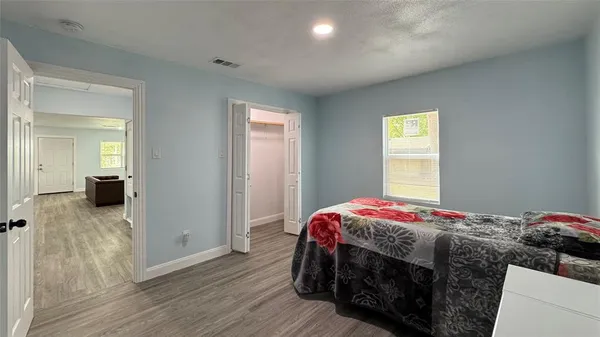 a bedroom with a bed and a window