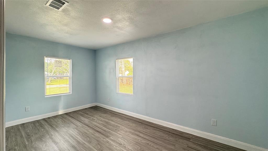 191 Harmon Road Gun Barrel City, TX 75156 - Photo 18 of 31 a view of an empty room with wooden floor and a window