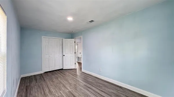 a view of an empty room and wooden floor