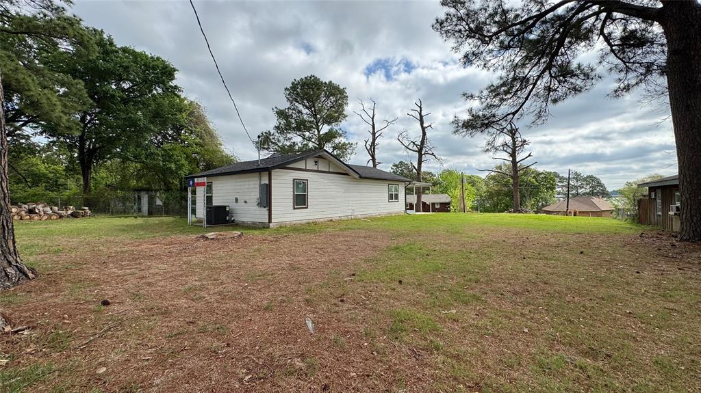 191 Harmon Road Gun Barrel City, TX 75156 - Photo 23 of 28 a view of a house with backyard and trees
