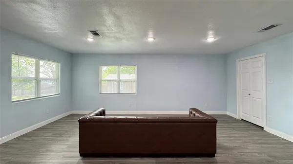a room with wooden floor and window