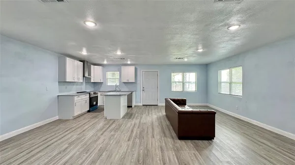 a view of kitchen with sink microwave refrigerator and stove