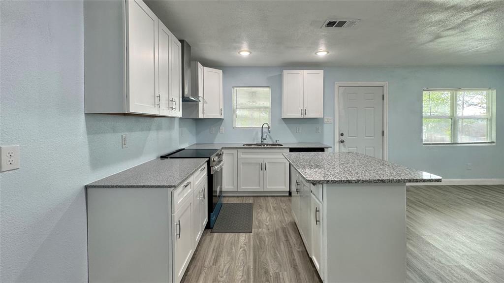191 Harmon Road Gun Barrel City, TX 75156 - Photo 9 of 28 a kitchen with granite countertop sink stove and cabinets