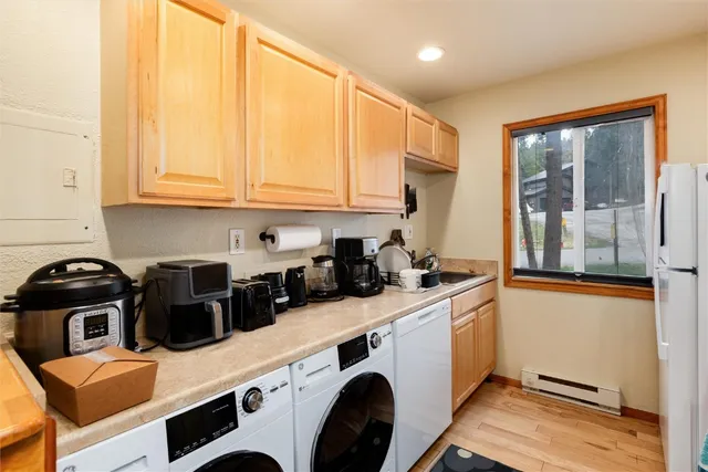 a kitchen with a sink a stove and cabinets