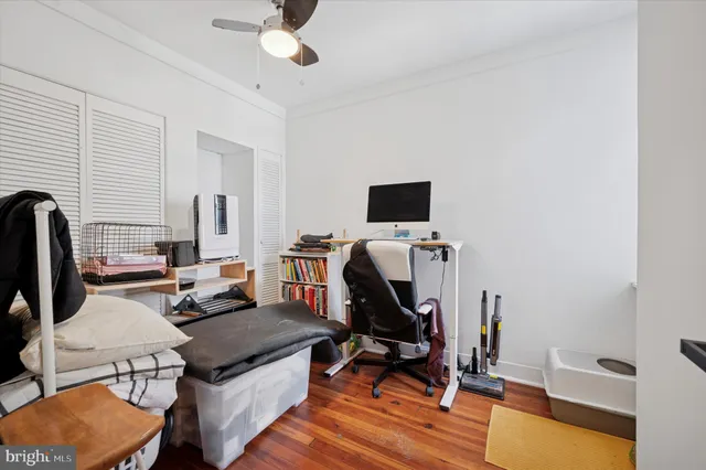 a view of a workspace with furniture and a flat screen tv