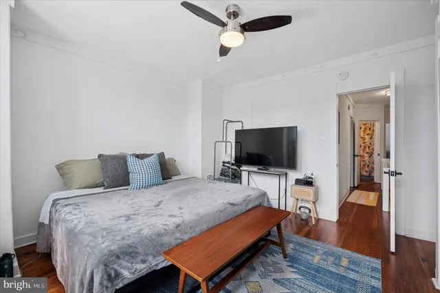 a bedroom with a bed and a large window with outer view