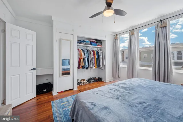 a view of a hallway with wooden floor and entryway