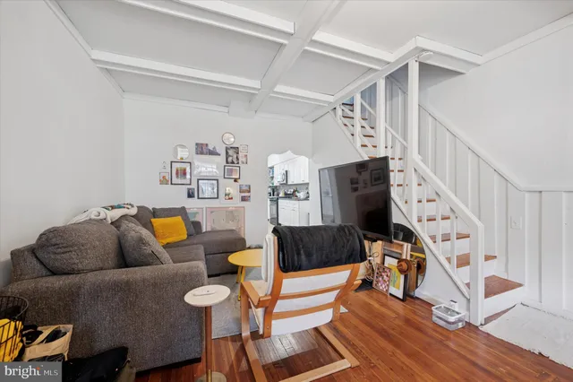 a living room with furniture a rug and a flat screen tv