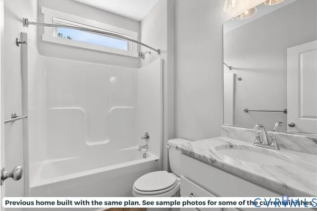 a bathroom with a granite countertop sink a mirror and a bathtub