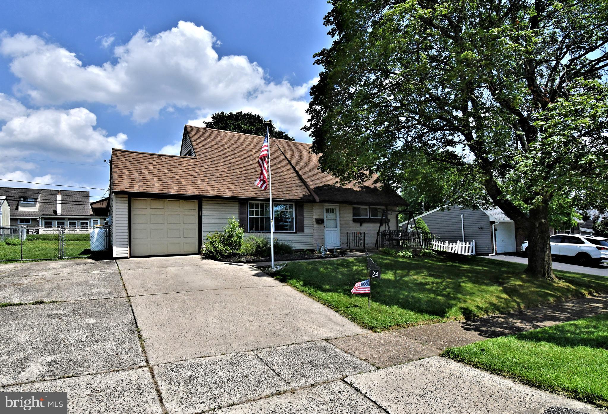 24 Conifer Road Levittown, PA 19057 - Photo 40 of 40 a front view of a house with a garden and trees