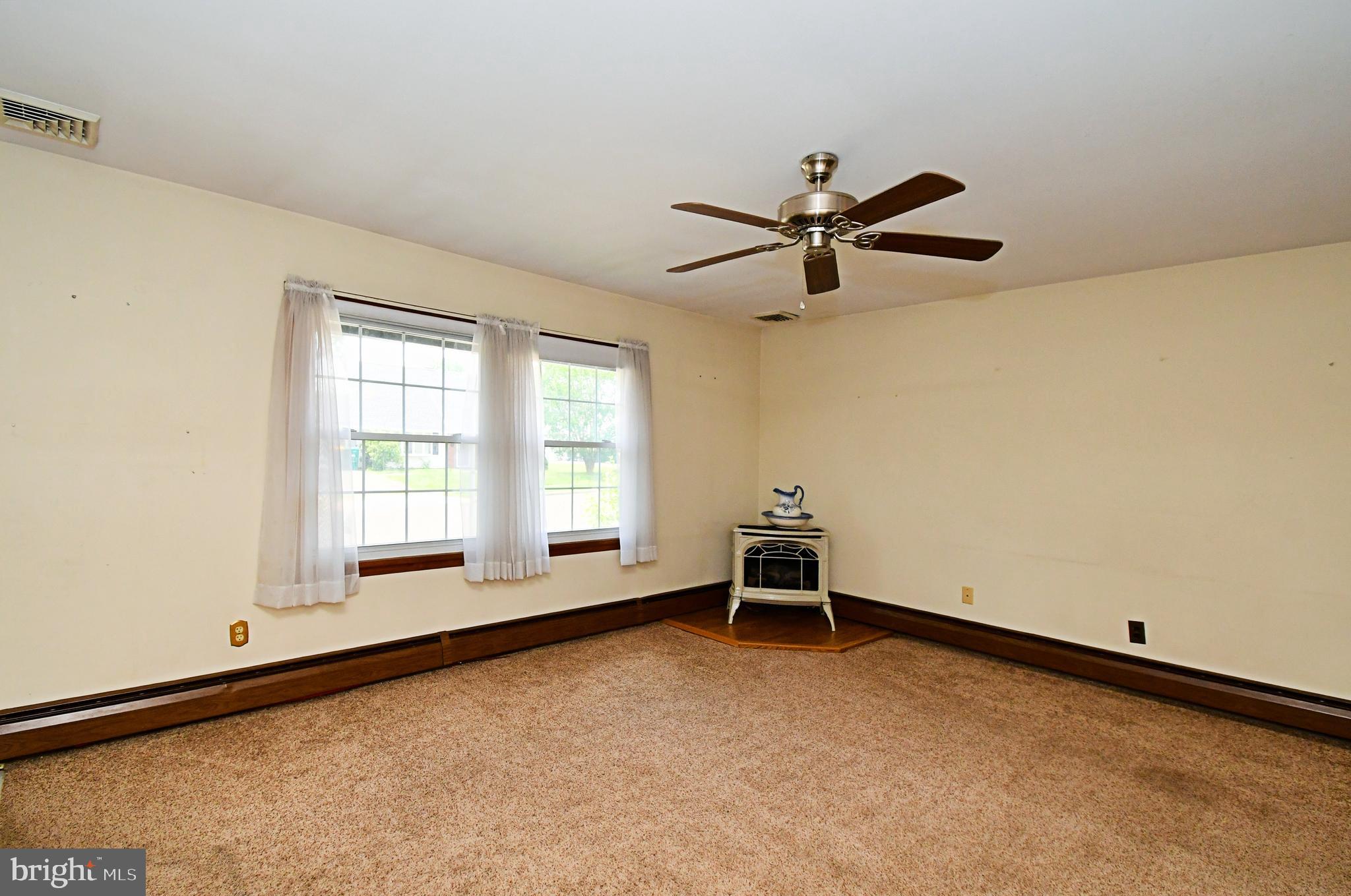 24 Conifer Road Levittown, PA 19057 - Photo 9 of 40 a view of room with a ceiling fan and a window