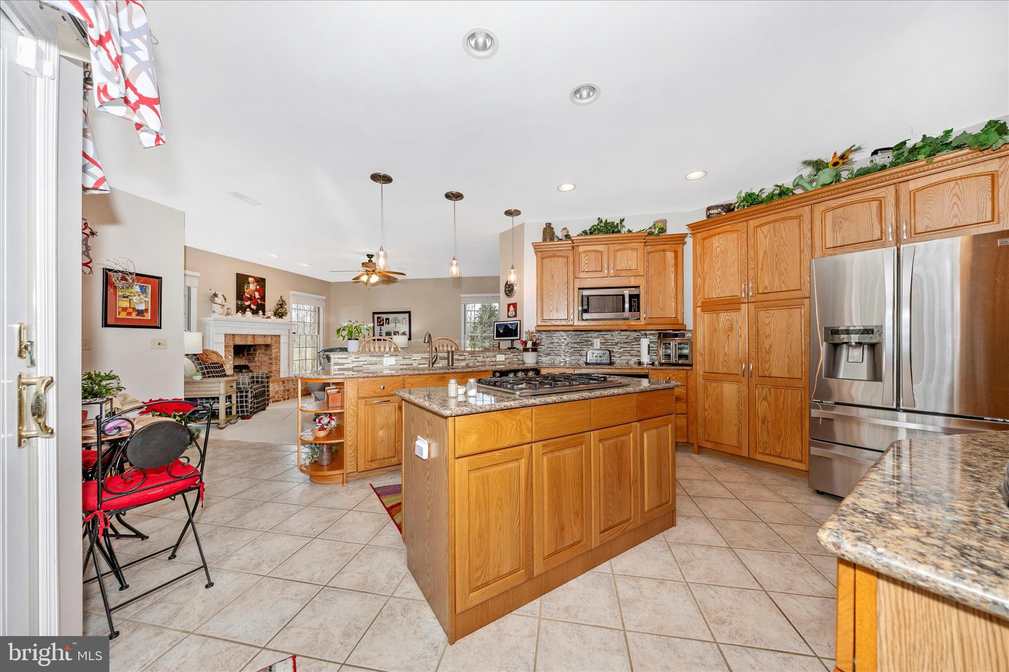 8971 Light Street Williamsport, MD 21795 - Photo 17 of 53 a large kitchen with stainless steel appliances kitchen island granite countertop a refrigerator and a sink
