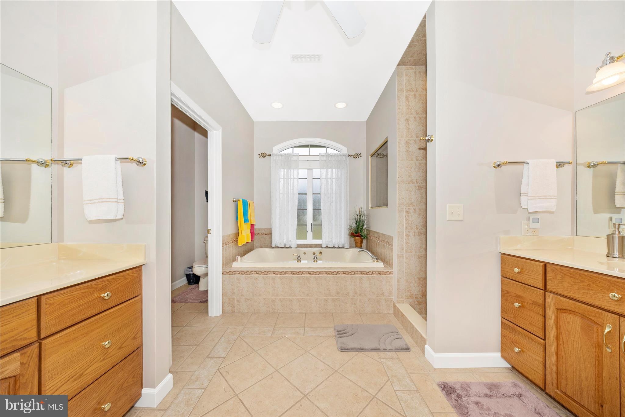 8971 Light Street Williamsport, MD 21795 - Photo 27 of 53 a spacious bathroom with a double vanity sink a mirror and a shower