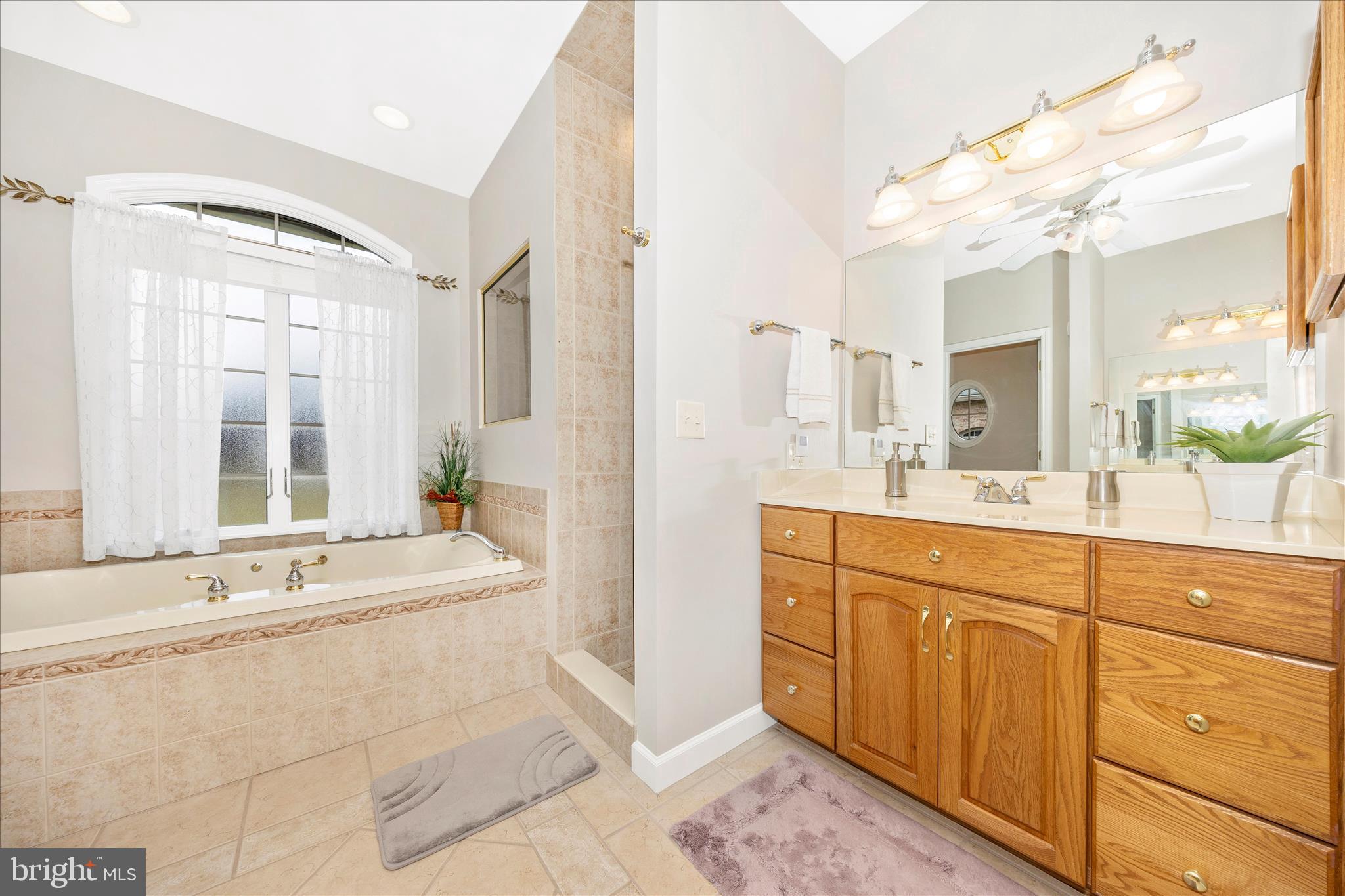 8971 Light Street Williamsport, MD 21795 - Photo 29 of 53 a spacious bathroom with a double vanity sink mirror and bathtub