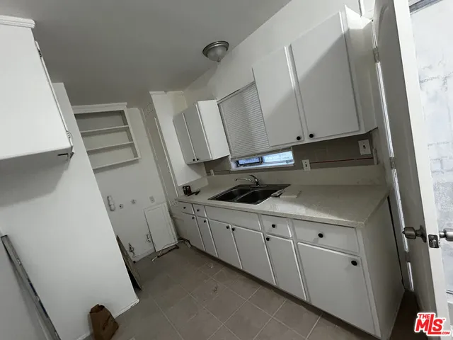 a kitchen with cabinets a sink and appliances