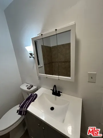 a bathroom with a sink a mirror and a window