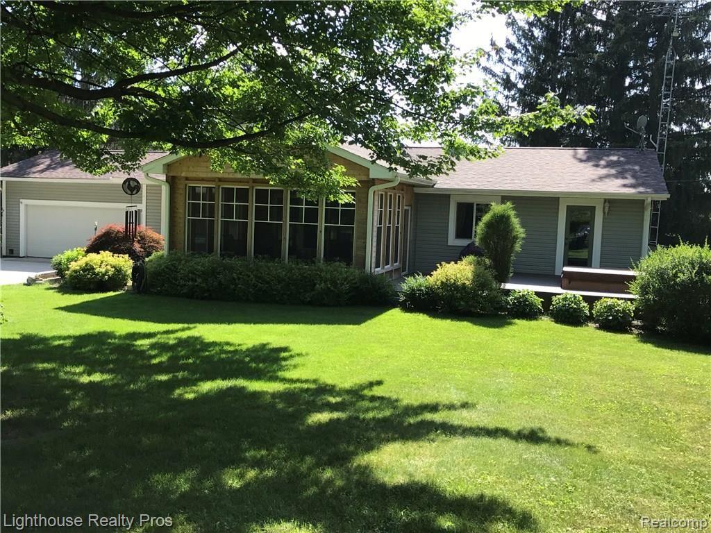 7150 Denton Hill Road Fenton, MI 48430 - Photo 2 of 47 Back of home with beautiful, fresh landscaping