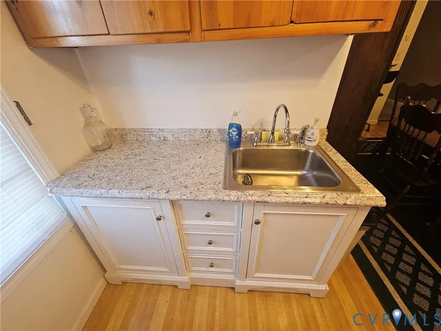 a kitchen with a sink stove and cabinets