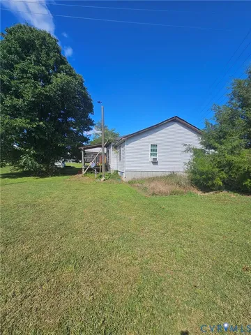a backyard of a house with lots of green space and garden