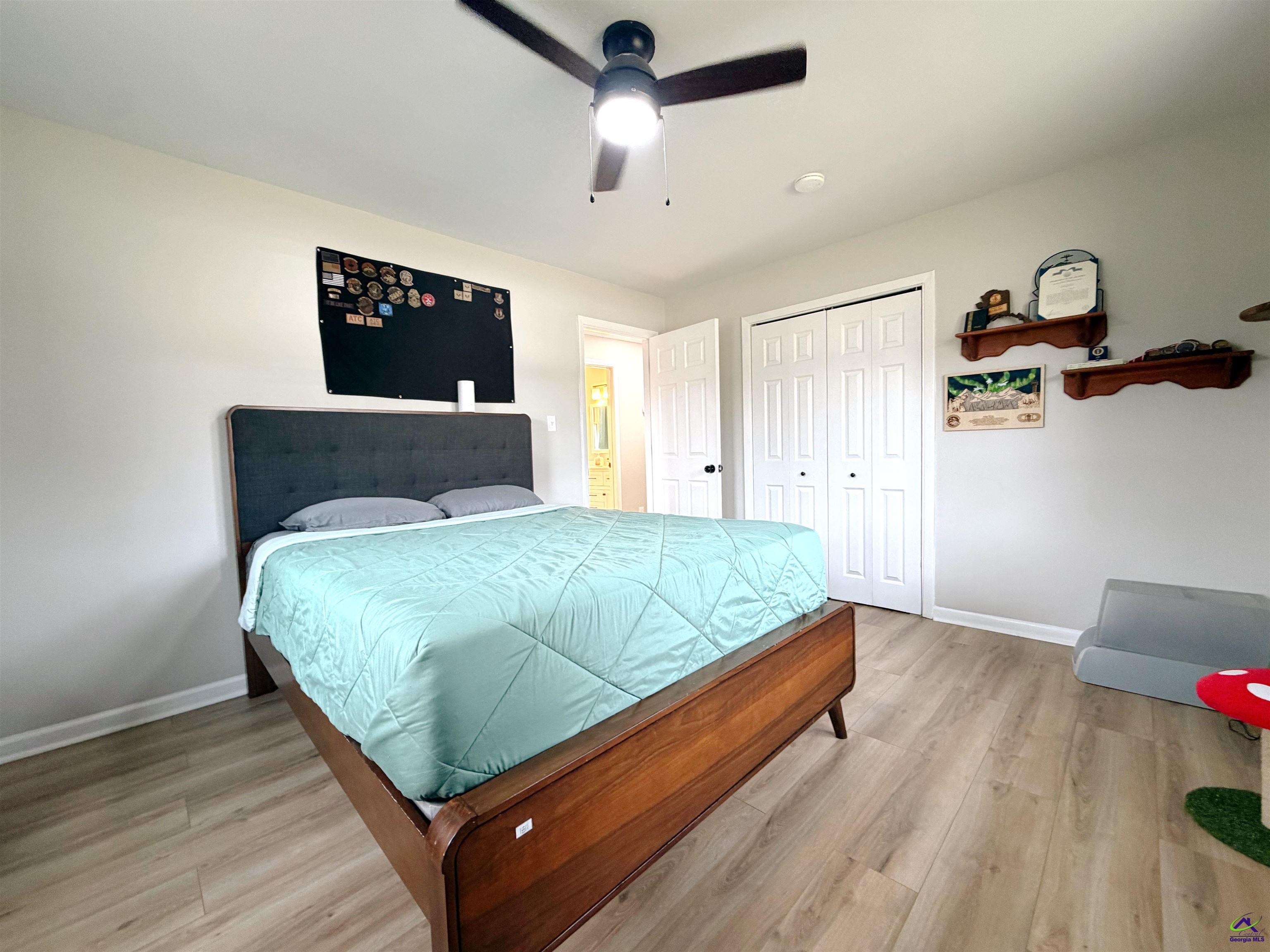 108 Weaver Road Warner Robins, GA 31093 - Photo 14 of 26 a bedroom with a bed and a desk