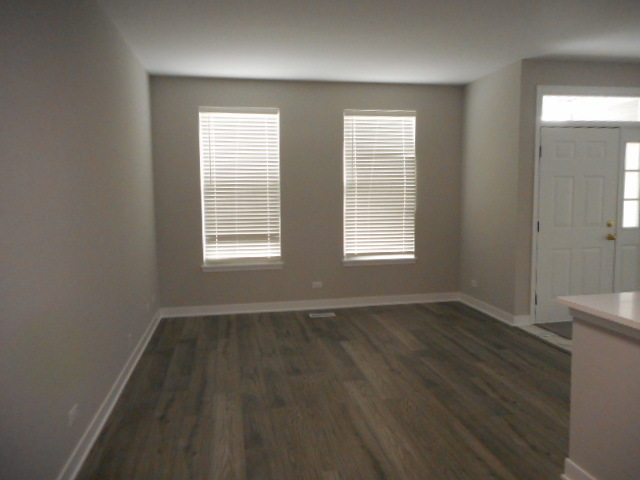 710 Timothy Court East Dundee, IL 60118 - Photo 3 of 25 an empty room with wooden floor and windows
