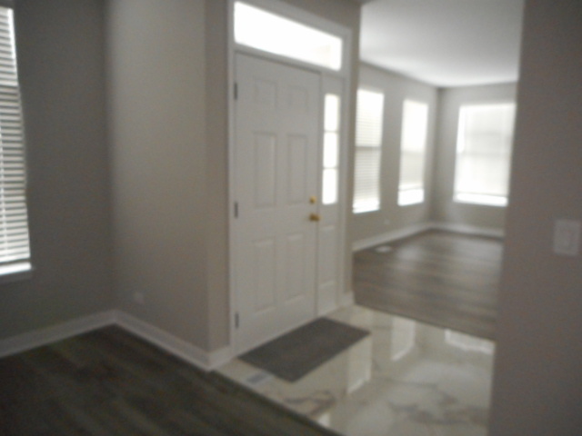 710 Timothy Court East Dundee, IL 60118 - Photo 5 of 25 an empty room with wooden floor and windows