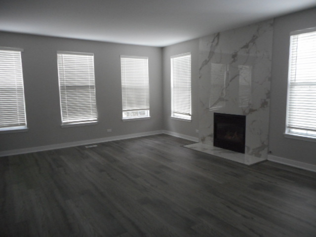 710 Timothy Court East Dundee, IL 60118 - Photo 8 of 25 a view of an empty room with wooden floor and a window
