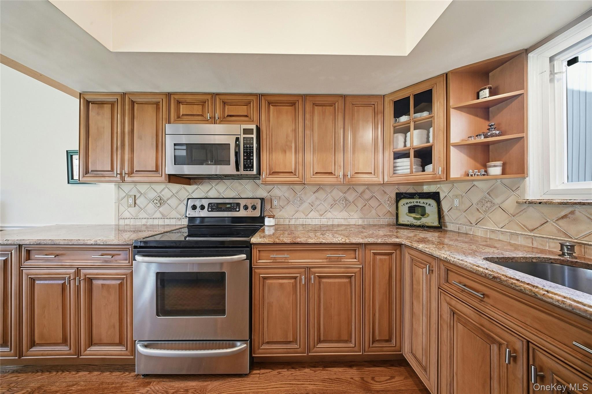 78 Hidden Ridge Drive Syosset, NY 11791 - Photo 5 of 21 a kitchen with cabinets appliances and a sink