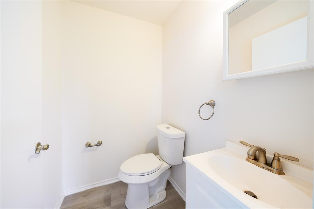714 East 12th Street Bonham, TX 75418 - Photo 17 of 18 a bathroom with a sink and toilet
