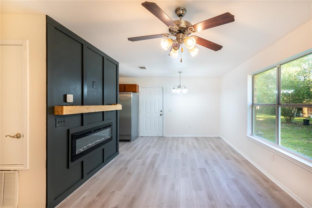 714 East 12th Street Bonham, TX 75418 - Photo 2 of 18 wooden floor in an empty room with a window