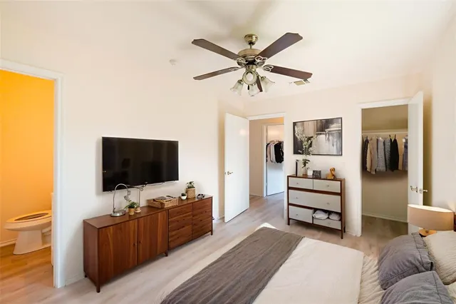 a bedroom with a bed and a flat screen television