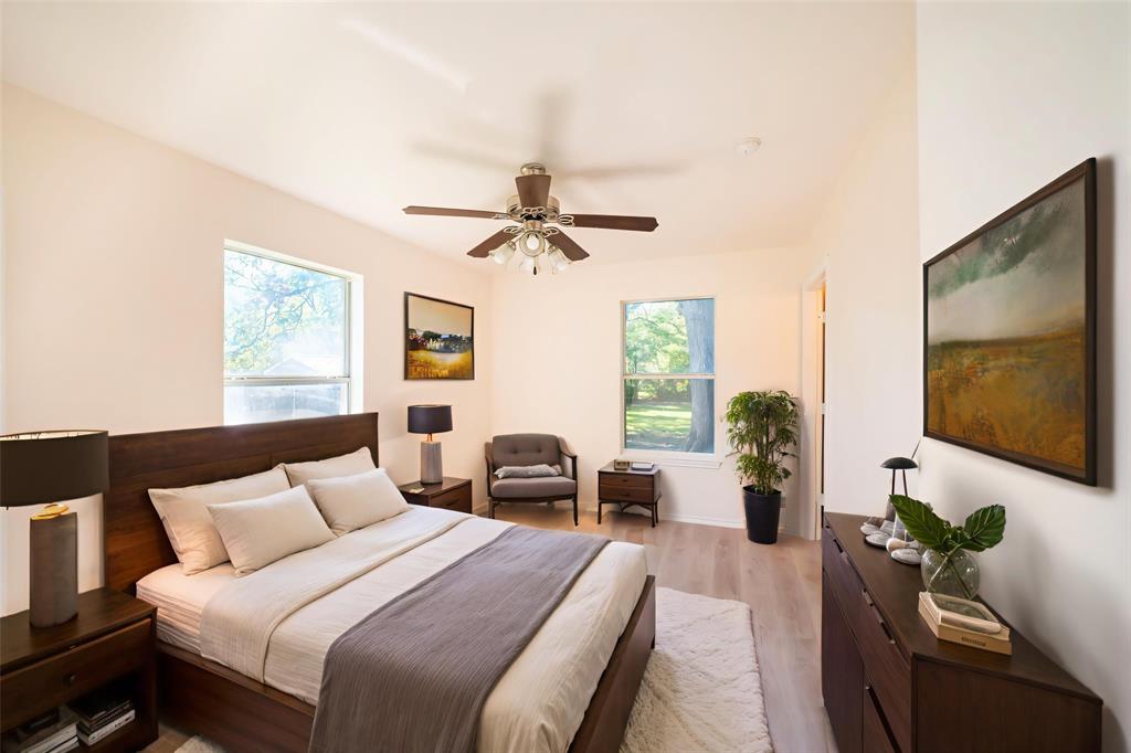 714 East 12th Street Bonham, TX 75418 - Photo 8 of 18 a bedroom with a bed and a flat screen tv