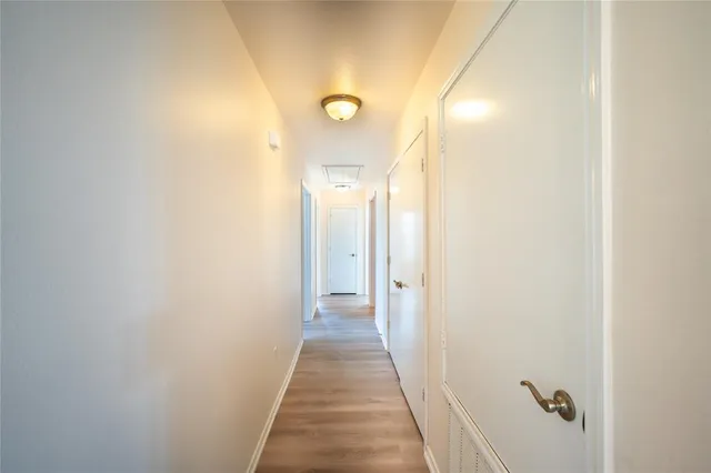 an empty room with a window and a ceiling fan