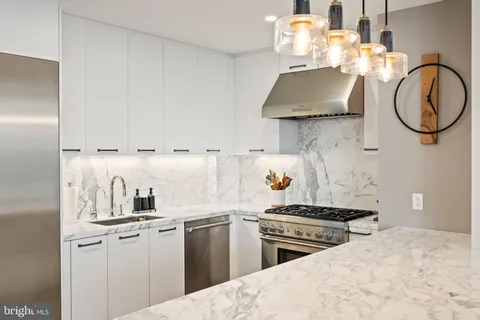 a view of a living room and kitchen floor to ceiling windows