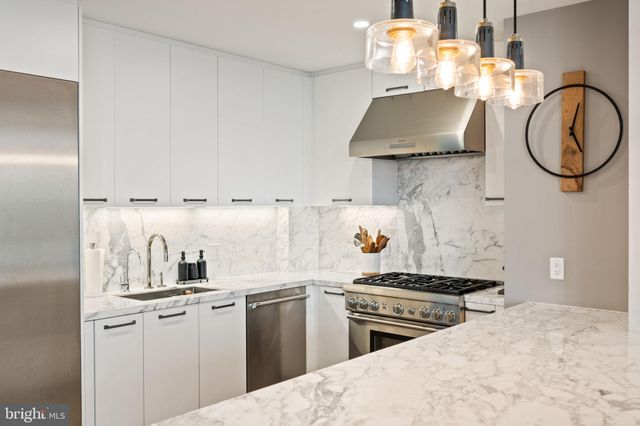 a view of a living room and kitchen floor to ceiling windows