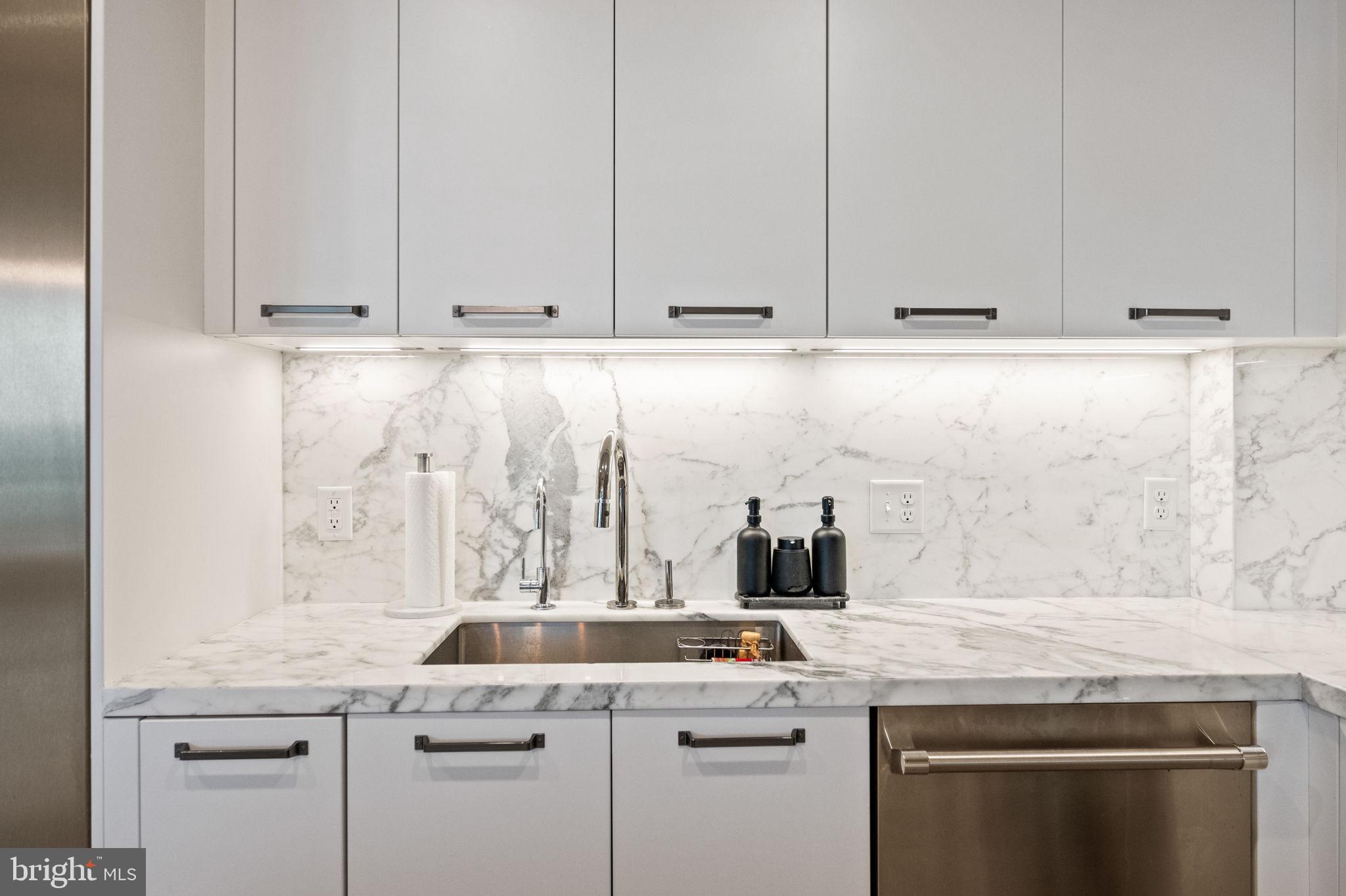 1330 Lancaster Street, Unit C603 Baltimore, MD 21231 - Photo 12 of 63 a kitchen with granite countertop white cabinets and a sink