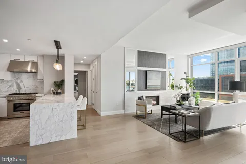 a kitchen with stainless steel appliances granite countertop a refrigerator a stove and a sink