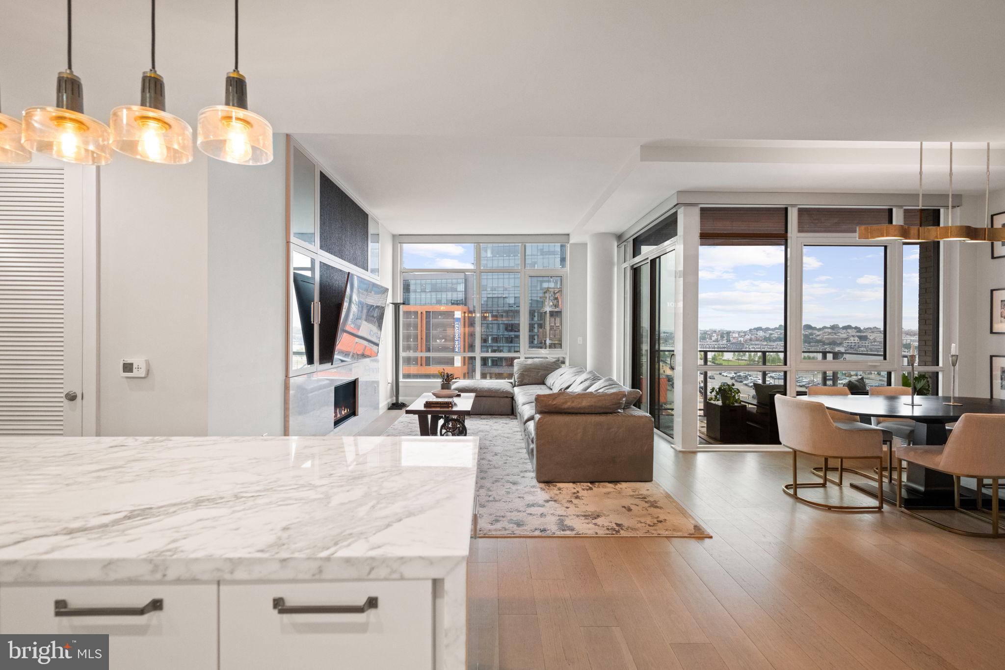 1330 Lancaster Street, Unit C603 Baltimore, MD 21231 - Photo 13 of 63 a view of a living room and kitchen floor to ceiling windows